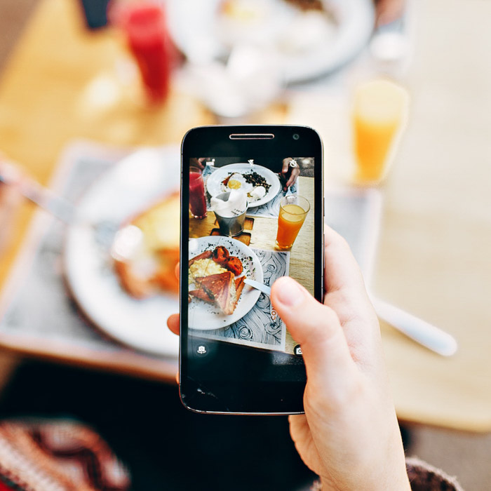 A smartphone being used to take a photo of food 