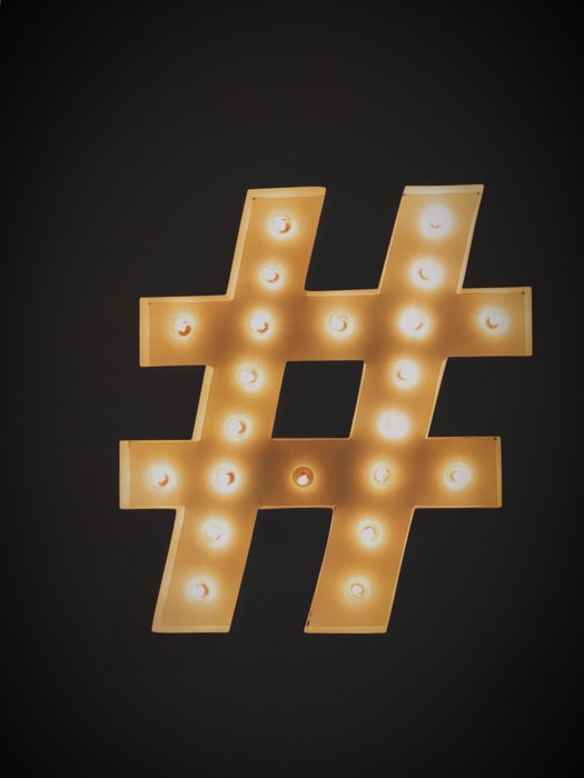A golden instagram hashtag on black background
