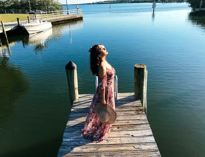 a female model posing on a small pier shot at a high camera angle