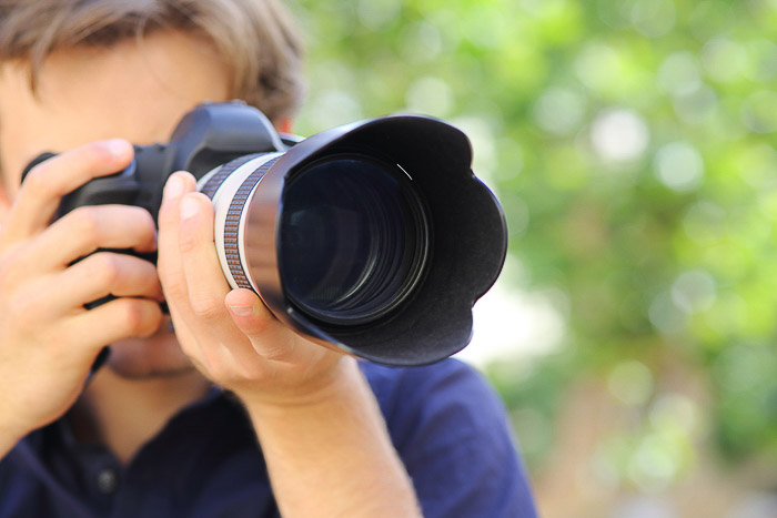A photographer taking a shot with a DSLR camera - understanding different camera parts