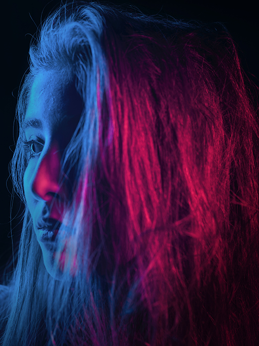Atmospheric neon portrait of a female model shot using neon photography