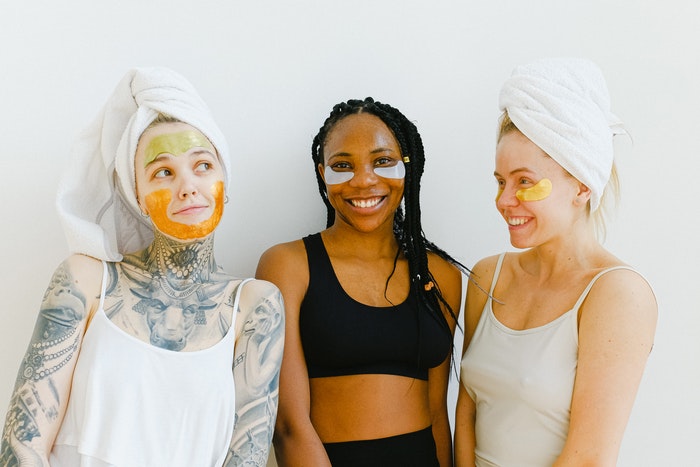 Three women wearing face masks