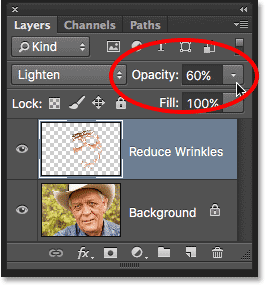 Lowering the opacity of the Reduce Wrinkles layer. Image © 2016 Photoshop Essentials.com